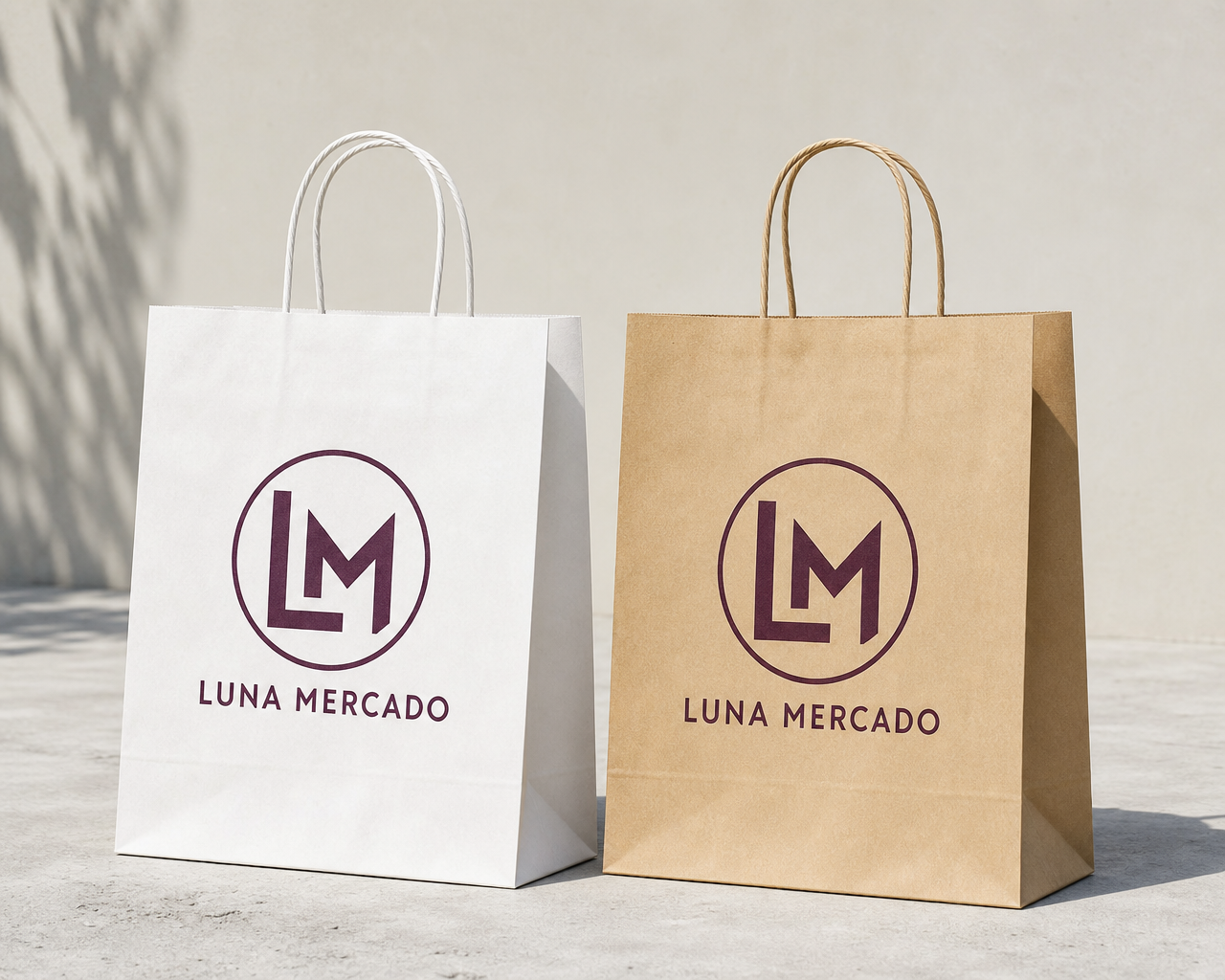 Kraft and white paper shopping bags with twisted handles printed with a boutique logo