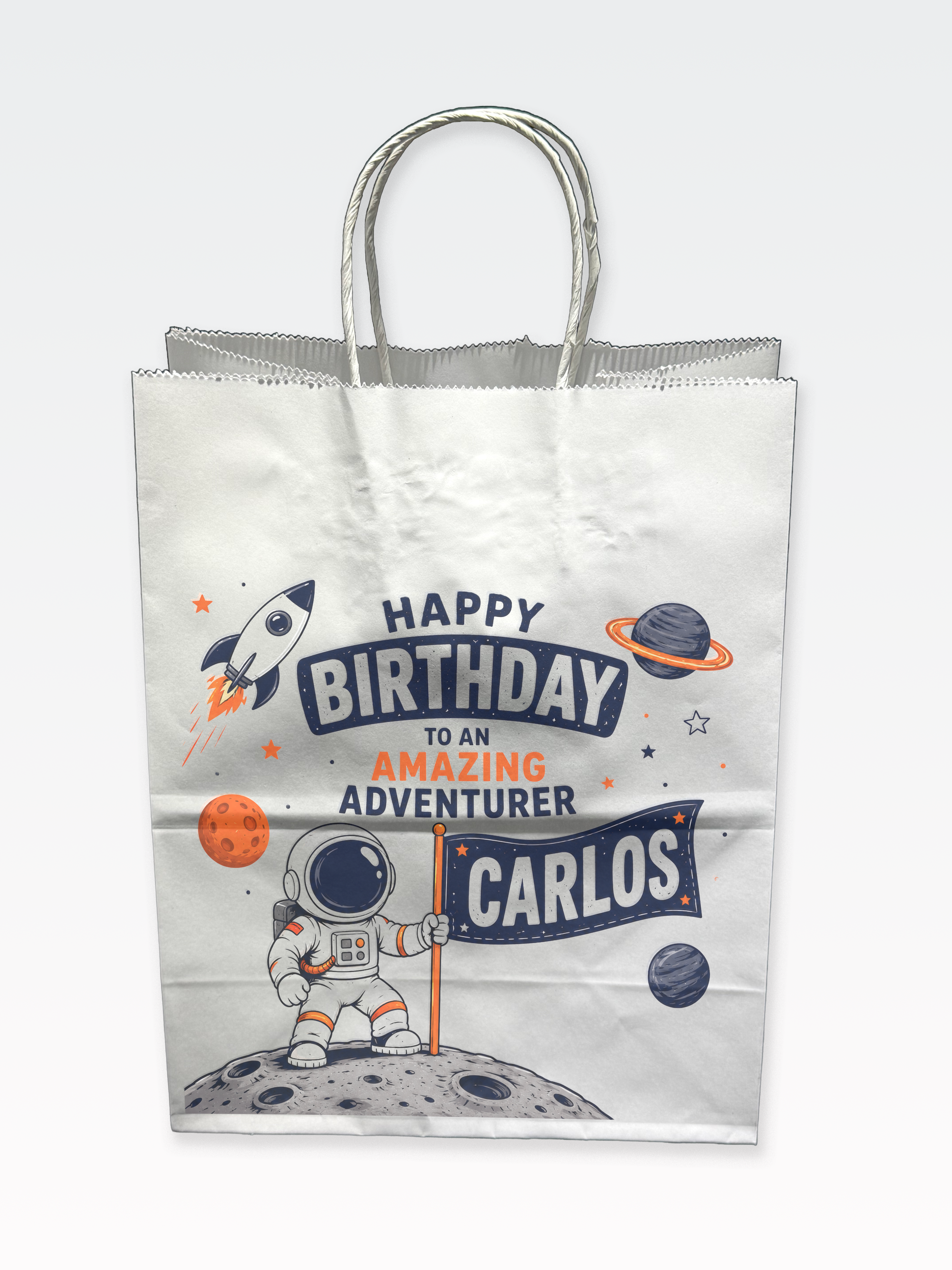 Space-themed birthday party bag printed with a child's name